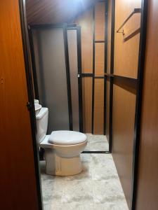 a bathroom with a toilet sitting in a room at Yala Wild Safaris Camp in Tissamaharama