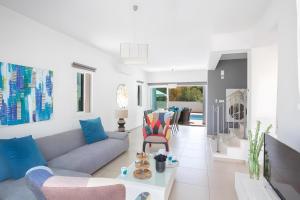 a living room with a couch and chairs at Casa de Nicole in Protaras