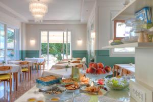 uma sala de jantar com uma mesa com comida em Hotel Villa Europa em Gargnano