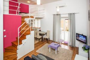 a living room with a staircase and a dining room at Apartment Dora in Split