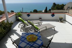 a patio with a table and chairs on a roof at Villa Emily in Licata