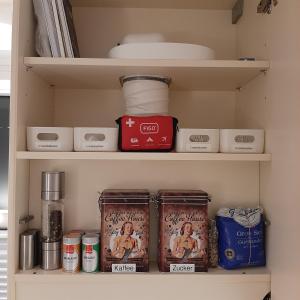 a kitchen pantry with food items on shelves at Seestern in Grömitz