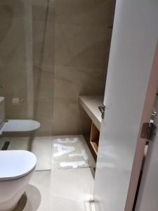 a bathroom with a toilet and a sink at Latchi Marina View in Polis Chrysochous