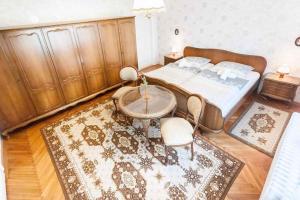 a bedroom with a bed and a table and a rug at Holiday home in Budapest 34304 in Budapest