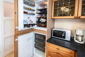 a kitchen with a refrigerator and a microwave at Holiday home in Budapest 34304 in Budapest