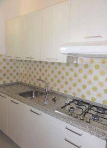 eine Küche mit einer Spüle und einer Arbeitsplatte in der Unterkunft Holiday Homes in Bibione 36266 in Bibione