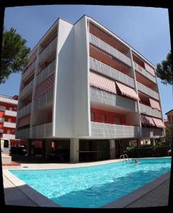 ein Gebäude mit einem Pool vor einem Gebäude in der Unterkunft Apartment in Bibione 38277 in Bibione