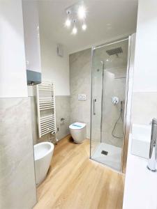 a bathroom with a shower and a toilet and a sink at Apartments in Bibione 36469 in Bibione