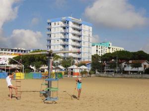 two children playing on a beach with a volley ball at Apartments in Bibione 36469 in Bibione