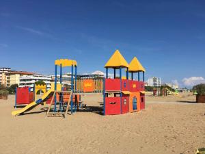 a playground with a slide on the beach at Holiday home in Bibione 41088 in Lo Stallone