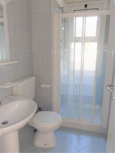 a bathroom with a toilet and a sink and a shower at Holiday home in Bibione 41088 in Lo Stallone