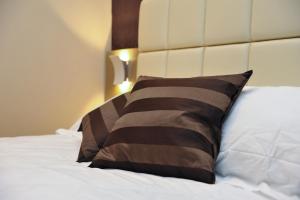 Un ou plusieurs lits dans un hébergement de l'établissement Hotel Dori