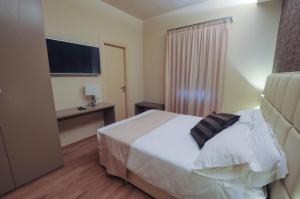 Un ou plusieurs lits dans un hébergement de l'établissement Hotel Dori
