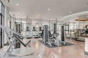 a gym with cardio equipment in a large room at Luxe Houston by the Galleria, Free parking in Houston