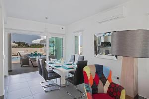 a dining room and living room with a table and chairs at Casa de Nicole in Protaras