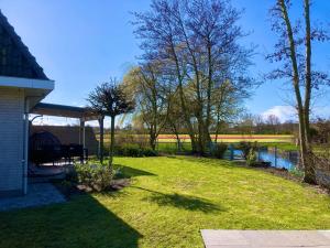 a yard with a gazebo and a pond at Maralong Noordwijk in Noordwijk
