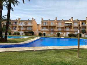 a swimming pool in front of a large building at ALOJAMIENTO ARENAL PARK in Jávea