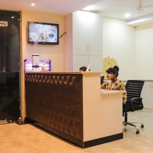 a woman sitting at a desk in an office at The Cape Grace Hotel in Jalandhar
