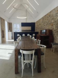 a dining room with a large wooden table and chairs at Bagolyvár Fogadó- Újfalusy Márton Vendégház in Zirc