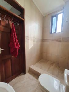 a bathroom with a shower with a toilet and a sink at Spacious Holiday Let Wi-Fi & Private Amenities Oyibi in Oyibi