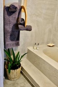 a bathroom with a bath tub and a towel at Antares Villa in Kiwengwa