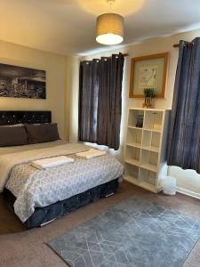 a bedroom with a bed and a large window at Amazing and Lovely 2- Bedroom First Floor Flat in London