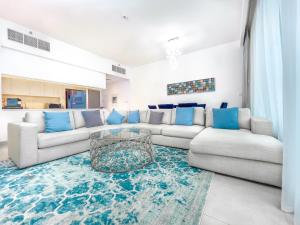 a living room with a couch and a table at FAM Living - Creek Horizon - 3B with Kids Room in Dubai