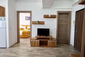 a living room with a television on a coffee table at Ena Sunrise Summerland in Mamaia