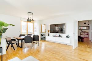 uma sala de jantar e sala de estar com mesa e cadeiras em Magnifique appartement 160m2 à 15mn de Paris em Vitry-sur-Seine