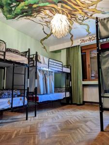 a room with bunk beds and a painting on the ceiling at Re-Born Hostel in Timişoara