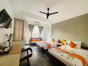 Ένα ή περισσότερα κρεβάτια σε δωμάτιο στο Boutique Indochine d'Angkor