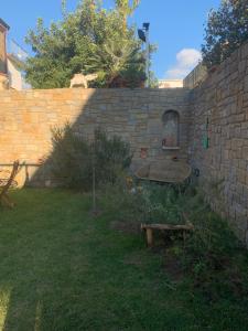 un muro di mattoni con tavolo in cortile di Cilento rooms ad Agnone