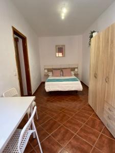 a bedroom with a bed and a tiled floor at CASA CORALES in La Mareta +8 photos