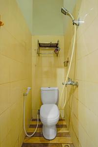 a bathroom with a toilet and a shower at OYO 92451 Hasan House Syariah 2 in Nagoya