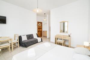 a living room with a couch and a table at Kristina Stelios Apartment in Platanias