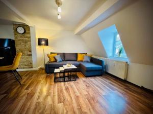 a living room with a blue couch and a table at Apartment Rheingold in Schwabach