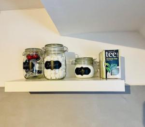 a shelf with jars of food and a box on it at Apartment Rheingold in Schwabach