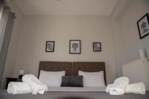 a bedroom with a bed with white towels on it at Dimitris Corinthian Villa in Vrahati