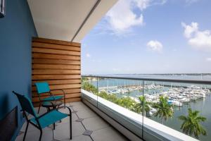 a balcony with two chairs and a view of a marina at SpringHill Suites by Marriott Bradenton Downtown/Riverfront in Bradenton