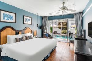 a bedroom with a bed and a pool at Away Chiang Mai Thapae Resort A Vegan Retreat in Chiang Mai +41 photos