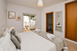 Ένα ή περισσότερα κρεβάτια σε δωμάτιο στο Albufeira Townhouses by OCvillas +34 φωτογραφίες
