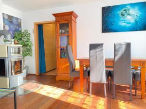 a dining room with a table and a fireplace at Residenz Bismarck - Ferienwohnung Maris in Ahlbeck