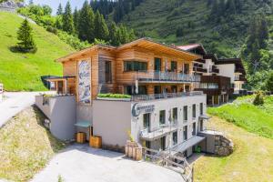 a house on the side of a mountain at Mondschein Hotel & Chalet in Stuben am Arlberg