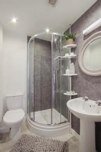 uma casa de banho com um chuveiro, um WC e um lavatório. em Apartments in the heart of Penzance em Penzance