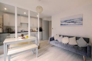 a living room with a couch and a table at Apartments in the heart of Penzance in Penzance +36 photos