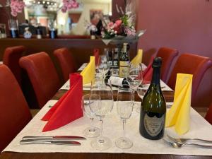 a table with glasses and a bottle of wine on it at Apartments am Rheingarten in Cologne