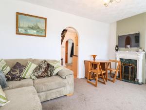 ein Wohnzimmer mit einem Sofa und einem Tisch in der Unterkunft 21 Crossways in Clacton-on-Sea