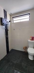 a bathroom with a toilet and a shower at Bertam Homestay Kepala Batas in Kepala Batas