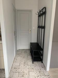 a hallway with a black table and a door at AU COEUR DE LA PUISAYE TOUT PRES DE GUEDELON in Saint-Amand-en-Puisaye
