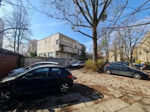 a black car parked in front of a building at Fantastic Mokotow - FMG Pokoj A in Warsaw